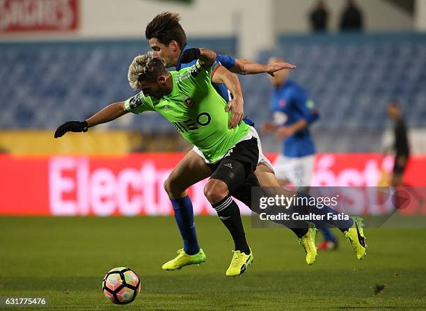 Rio Ave FC's midfielder Ruben Ribeiro tackled by Belenenses's forward Ortuno from Spain during the Primeira Liga match between CF Os Belenenses and...