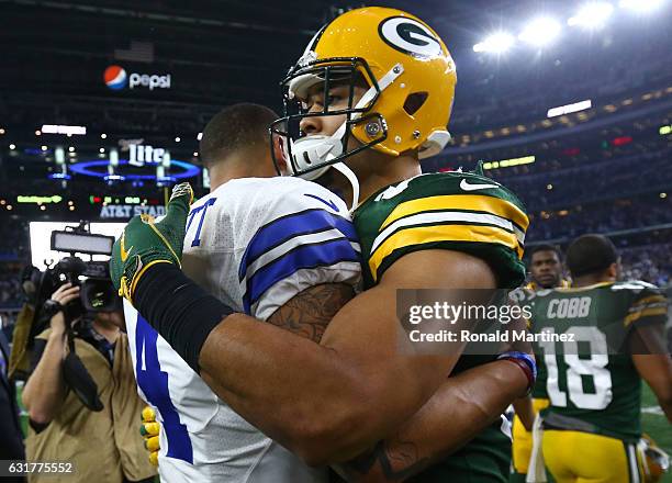 Dak Prescott of the Dallas Cowboys and Richard Rodgers of the Green Bay Packers congratulate each other at midfield after the NFC Divisional Playoff...