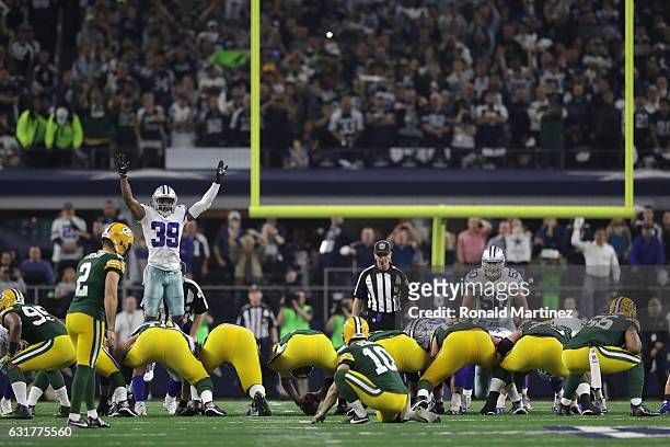 Mason Crosby of the Green Bay Packers lines up to kick the game-winning field goal against the Dallas Cowboys in the NFC Divisional Playoff game at...