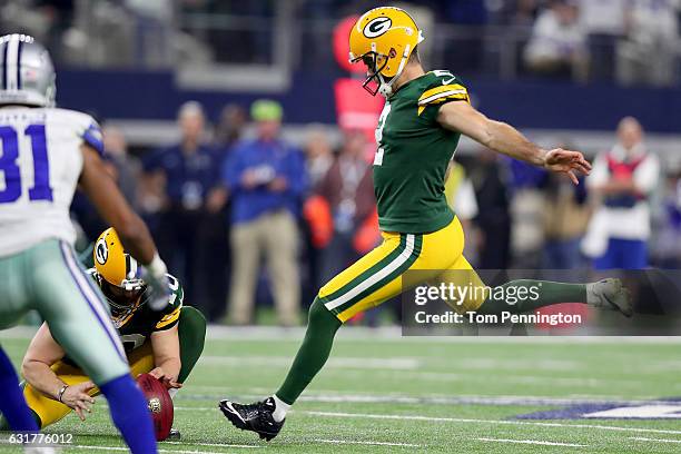 Mason Crosby of the Green Bay Packers kicks the game winning field goal against the Dallas Cowboys in the final seconds of a NFC Divisional Playoff...