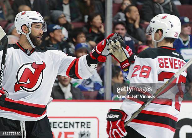 Kyle Quincey of the New Jersey Devils celebrates his goal with teammate Damon Severson during their NHL game against the Vancouver Canucks at Rogers...
