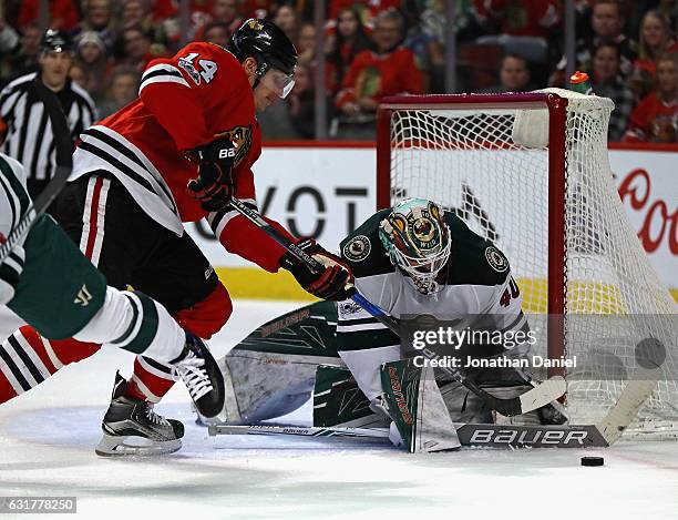 Devan Dubnyk of the Minnesota Wild makes a save against Richard Panik of the Chicago Blackhawks at the United Center on January 15, 2017 in Chicago,...