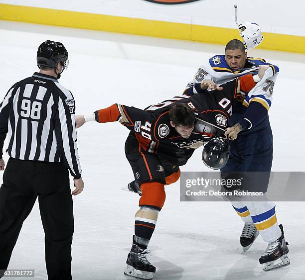 Ryan Reeves of the St. Louis Blues mixes it up with Jared Boll of the Anaheim Ducks as linesman John Grandt looks on during the game on January 15,...