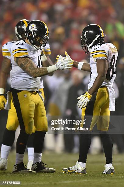 Fullback Roosevelt Nix-Jones of the Pittsburgh Steelers congratulates teammate wide receiver Antonio Brown after sealing the game with a first down...
