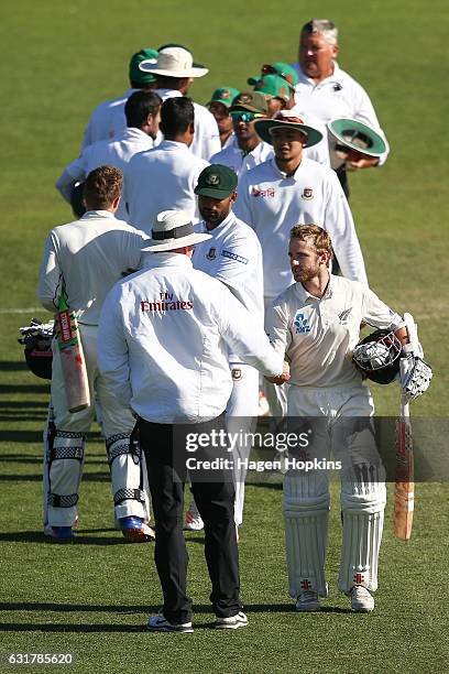 Umpire Paul Reiffel of Australia shakes the hand of Kane Williamson of New Zealand at the conclusion of day five of the First Test match between New...