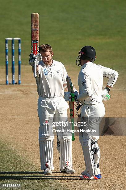 Kane Williamson of New Zealand celebrates his century with teammate Henry Nicholls during day five of the First Test match between New Zealand and...