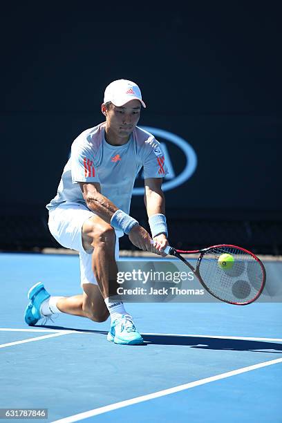 Go Soeda of Japan plays a Backhand in his first round match against Malek Jaziri of Tunisia on day one of the 2017 Australian Open at Melbourne Park...