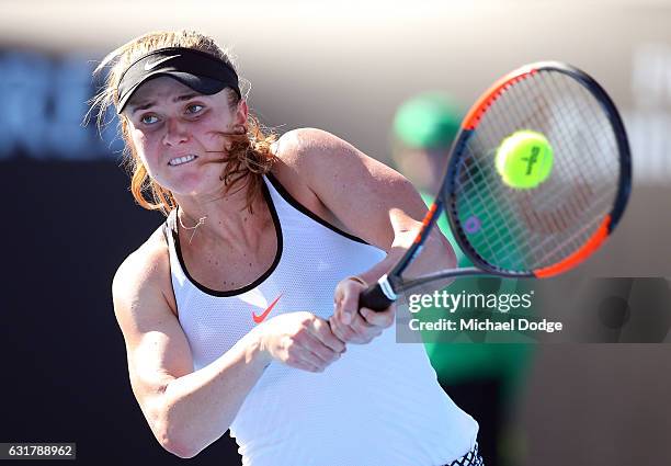Elina Svitolina of the Ukraine plays a backhand during her first round match against Galina Voskoboeva of Kazikstan on day one of the 2017 Australian...