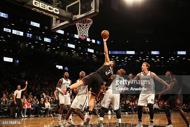 Bryan Anderson of Houston Rockets in action against Brandy Foye Justin Hamilton of Brookyln Nets during an NBA game in Barclays Center on January 15,...