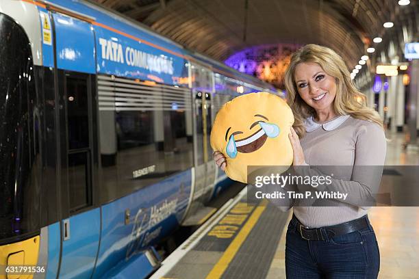 Carol Vorderman poses for a photo with a happy emoji to help cheer passengers on 'Blue Monday' and to highlight the Heathrow Express Service from...