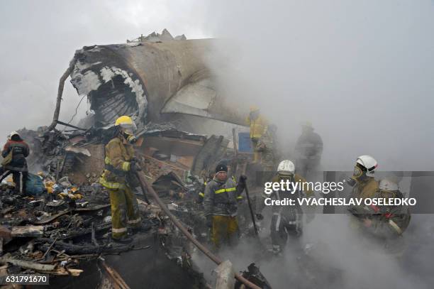 Rescue personnel work at the crash site of a Turkish cargo plane in the village of Dacha-Suu outside Bishkek on January 16, 2017. A Turkish cargo...