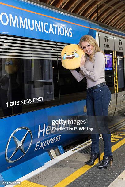 Carol Vorderman poses for a photo with a happy emoji to help cheer passengers on 'Blue Monday' and to highlight the Heathrow Express Service from...