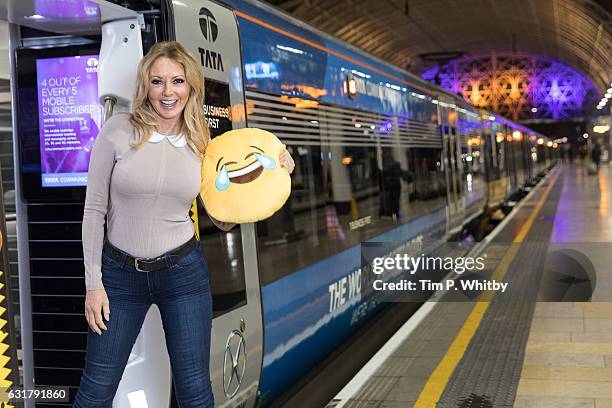 Carol Vorderman poses for a photo with a happy emoji to help cheer passengers on 'Blue Monday' and to highlight the Heathrow Express Service from...
