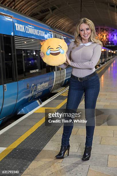 Carol Vorderman poses for a photo with a happy emoji to help cheer passengers on 'Blue Monday' and to highlight the Heathrow Express Service from...