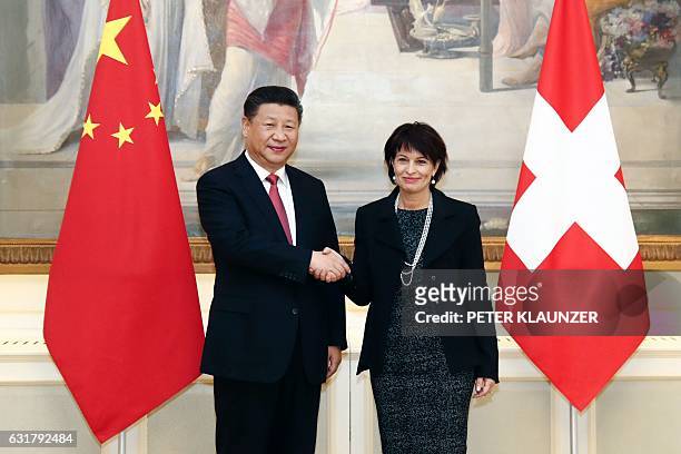 Swiss Federal President Doris Leuthard and China's President Xi Jinping pose for photographers prior to their official talks on January 16 in Bern....