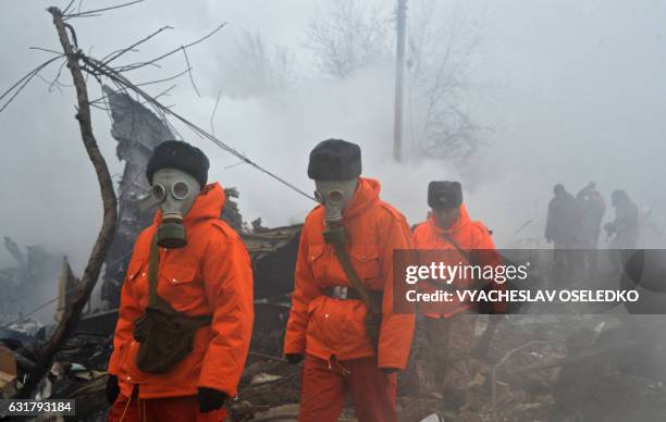 Rescue personnel work at the crash site of a Turkish cargo plane in the village of Dacha-Suu outside Bishkek on January 16, 2017. A Turkish cargo...