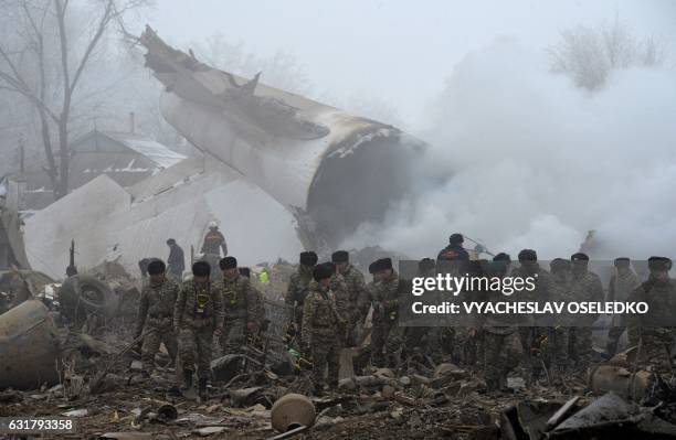 Rescue personnel work at the crash site of a Turkish cargo plane in the village of Dacha-Suu outside Bishkek on January 16, 2017. A Turkish cargo...