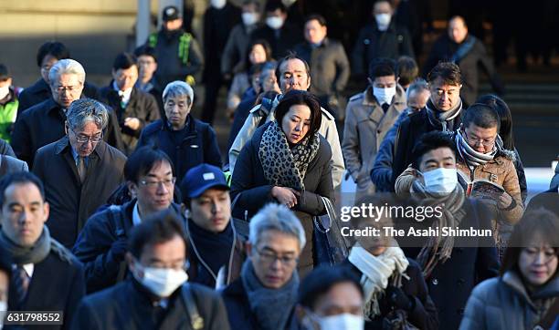 Commuters are bundled up to deal with the cold early in the morning on January 16, 2017 in Tokyo, Japan. The mercury hit minus 2 degrees in central...