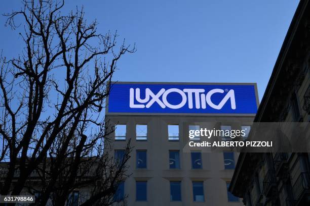 This picture taken on January 16, 2017 shows the logo of Italian eyewear company Luxottica in Milan. French lensmaker Essilor said on January 16,...