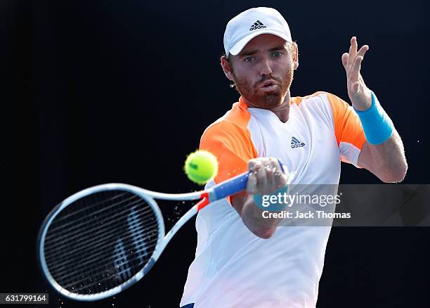 Bjorn Fratangelo of the United States plays a forehand in his first round match against Noah Rubin of the United States on day one of the 2017...