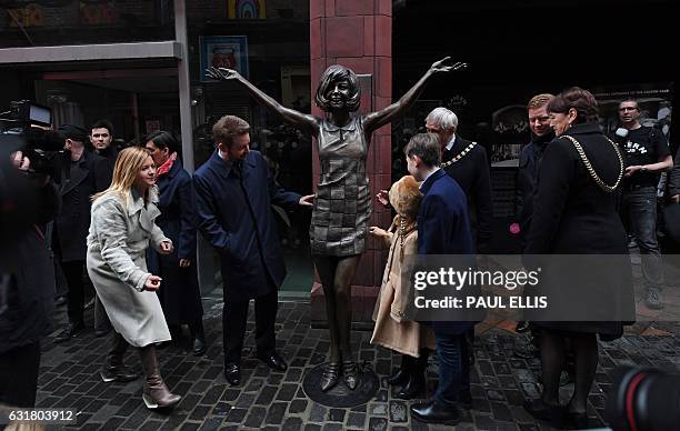 Robert Willis, a son of late British singer and TV personality Cilla Black, poses alongside a bronze statue of his mother, created by artists Emma...