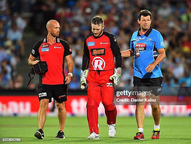 Peter Nevill of the Melbourne Renegades walks from the field after being struck in the head by the bat of Brad Hodge of the Adelaide Strikers during...