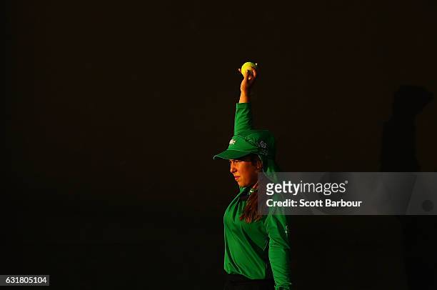 Ball kid prepares to throw a ball to Eri Hozumi of Japan as she plays in her first round match against Carina Witthoeft of Germany on day one of the...