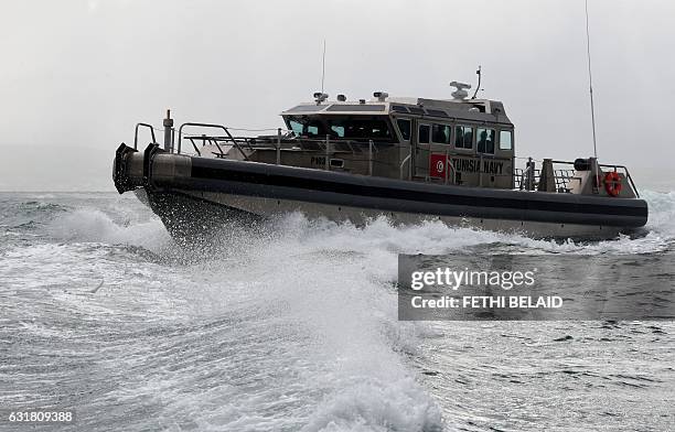 Tunisian soldiers navigate one of six ships given by the US military as they arrive at the Bizerte naval base on the northern coast of Tunisia on...