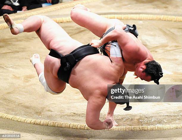 Mongolian Arawashi throws Mongolian ozeki Terunofuji to win during day nine of the Grand Sumo New Year Tournament at Ryogoku Kokugikan on January 16,...