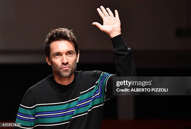 Designer Massimo Giorgetti greets the audience at the end of the show for fashion house MSGM during the Men's Fall-Winter 2017-2018 fashion week on...