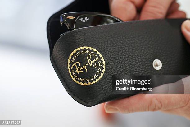 Pair of Ray-Ban Clubmaster sunglasses, manufactured by Luxottica Group SpA, are placed into a case in an opticians in London, U.K., on Monday, Jan....