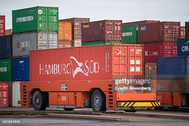 An automated guided vehicle transports a Hamburg Sued shipping container on the dockside at the Delta Terminal, operated by Europe Container...