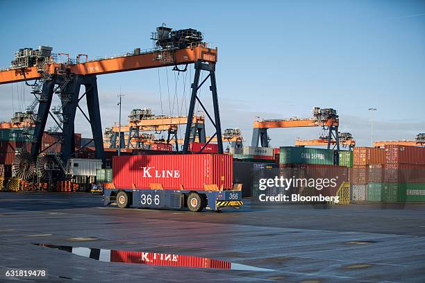 An automated guided vehicle transports a K Line shipping container on the dockside at the Euromax terminal, operated by Europe Container Terminals BV...