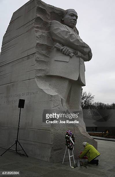Sharon Lambdin lays flowers at the base of the Martin Luther King Jr. Memorial as she visits on the day that honors him on January 16, 2017 in...