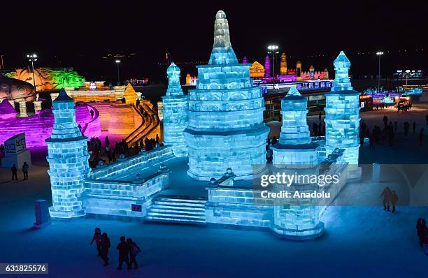 Tourists visit an illuminated ice castle during the 33rd Harbin International Ice and Snow Festival at Harbin Ice And Snow World in Harbin, China on...