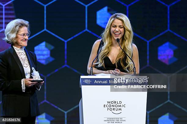 Colombian singer Shakira , flanked by Chairperson of the Schwab Foundation Hilde Schwab, delivers a speech during the Crystal Award ceremony on the...