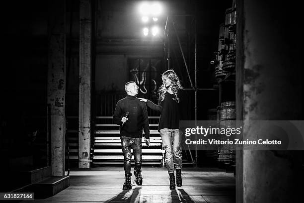 The designer is seen on the catwalk with Sasha Pivovarova ahead of the Dsquared2 show during Milan Men's Fashion Week Fall/Winter 2017/18 on January...