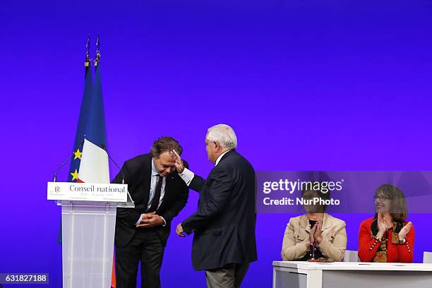 Former French Prime Minister Jean-Pierre Raffarin gestures toward the president of the National Council of the Les Republicains party, Luc Chatel ,...