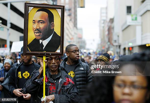 Osie James carries a photo of Dr. Martin Luther King Jr. During the annual Martin Luther King Day march on January 16, 2017 in Memphis, Tennessee....