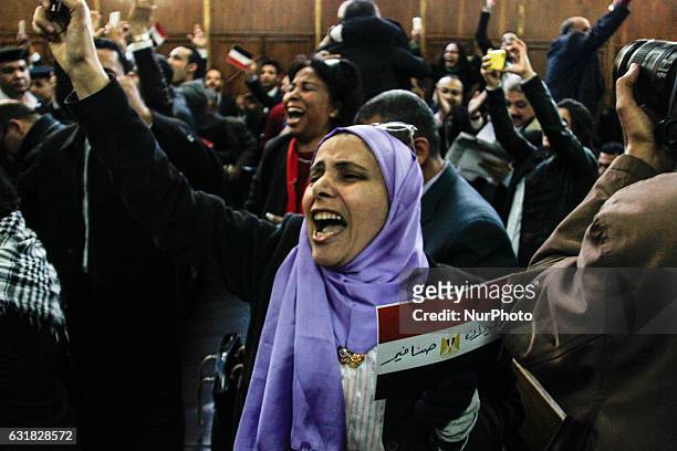 An Egyptian woman celebrates with a national flag defaced with the words &quot;Tiran&quot; and &quot;Sanafir&quot; after the High Administrative...