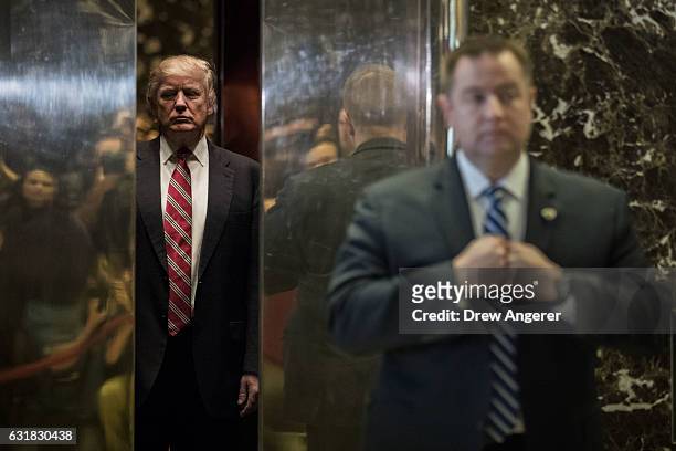 President-elect Donald Trump heads back into the elevator after shaking hands with Martin Luther King III after their meeting at Trump Tower, January...