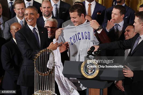 President Barack Obama is given a uniform by Major League Baseball World Series champion Chicago Cubs player Anthony Rizzo during a celebration of...
