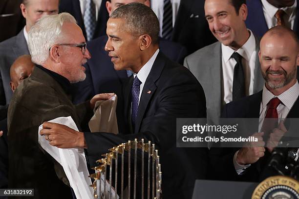 President Barack Obama embraces Major League Baseball World Series champion Chicago Cubs Manager Joe Maddon while celebrating his team's win in the...