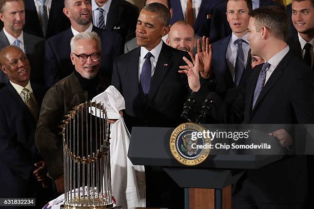 President Barack Obama encourages people not to push his honorary 'fan' status during a celebration of the Major League Baseball World Series...