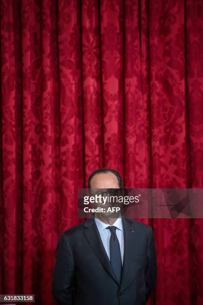 French President Francois Hollande looks on during a ceremony to award the Legion of Honour to the US ambassador to France at the Elysee Palace in...