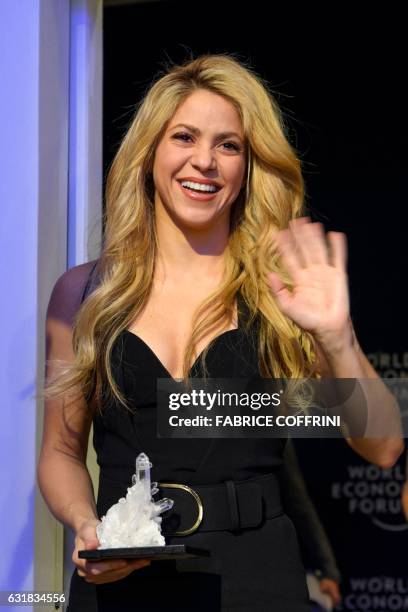 Colombian singer Shakira poses with her award after the Crystal Award ceremony on the eve of the opening day of the World Economic Forum, on January...