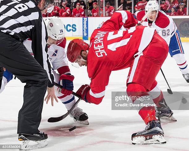 Riley Sheahan of the Detroit Red Wings faces off against Tomas Plekanec of the Montreal Canadiens during an NHL game at Joe Louis Arena on January...