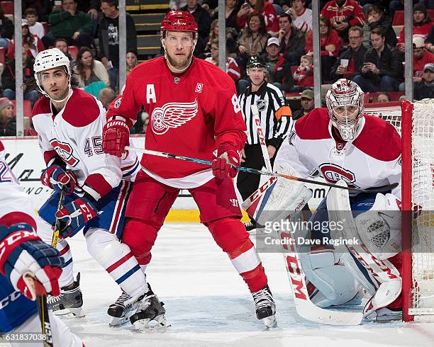 Justin Abdelkader of the Detroit Red Wings battles for position with Mark Barberio of the Montreal Canadiens in front of Carey Price of the Canadiens...