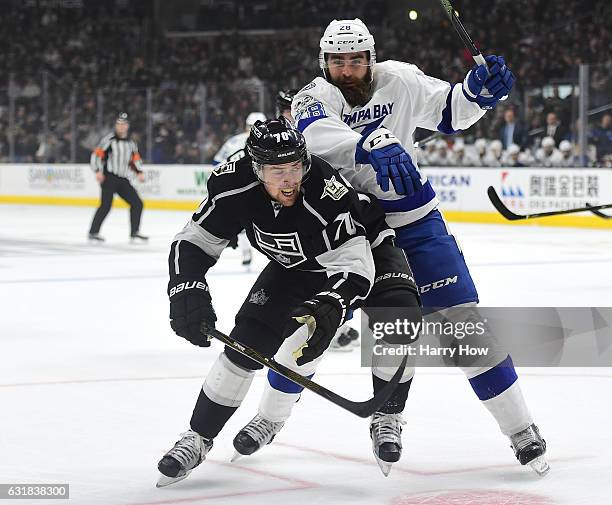 Tanner Pearson of the Los Angeles Kings bumps Luke Witkowski of the Tampa Bay Lightning as they chase a puck to the boards during the first period at...