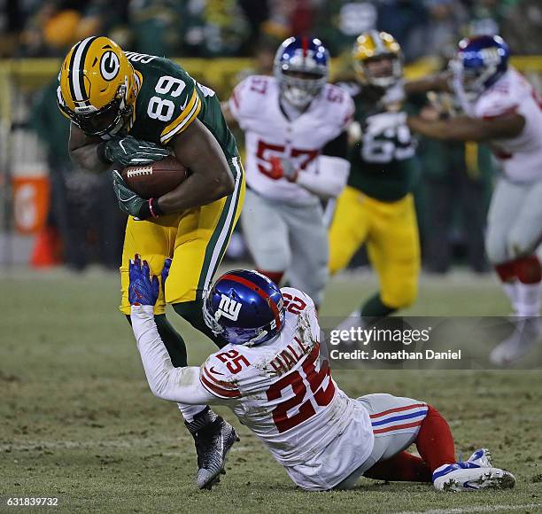 Jared Cook of the Green Bay Packers is grabbed by Leon Hall of the New York Giants at Lambeau Field on January 8, 2017 in Green Bay, Wisconsin.